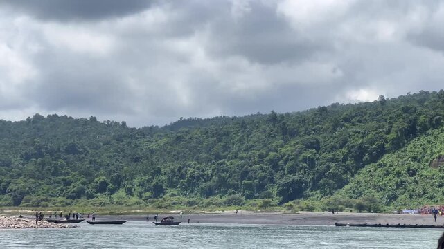 Jaflong Sylhet Riverscape with lush green hills and people on boats, cinematic footage capturing tranquil nature