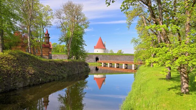 Kuressaare Castle tower reflecting in the moat in Estonia