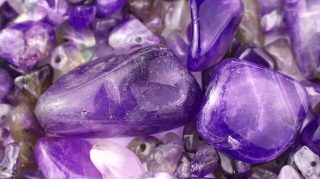 Purple and violet amethyst stone crystals and gems circle rotation close up