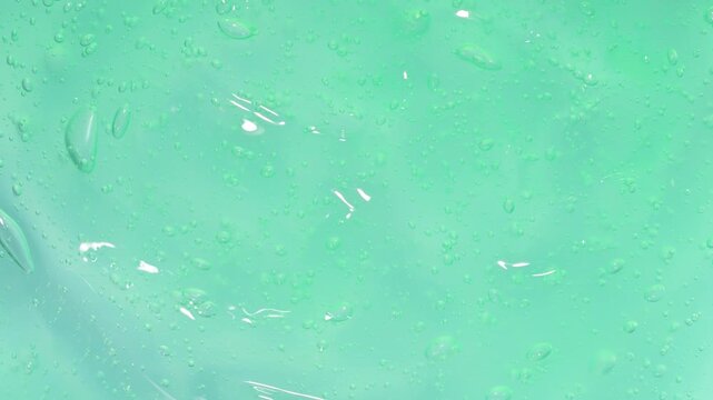 Background of transparent green gel with bubbles
