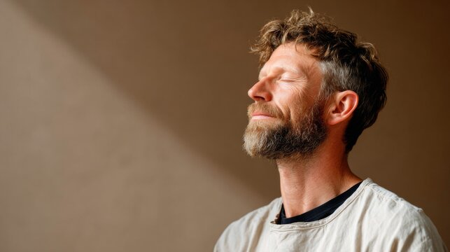 Bearded man meditating with closed eyes in peaceful mindfulness meditation
