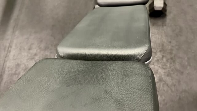 Empty Weight Bench and Dumbbells in a Quiet Gym