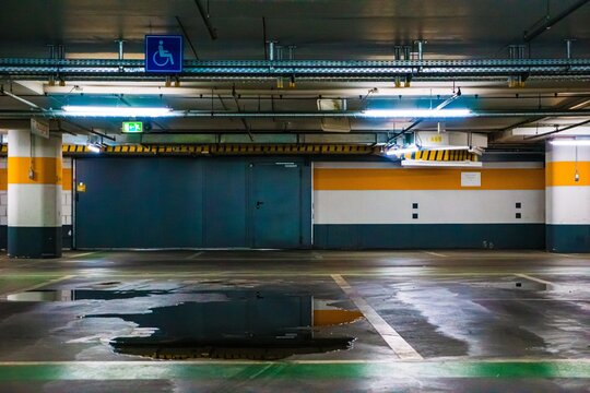 Empty parking garage with wet floor and lights