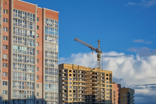 Apartment blocks and a construction site with a tower crane.
