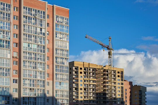 Apartment blocks and a construction site with a tower crane.