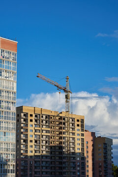 Apartment blocks and a construction site with a tower crane.