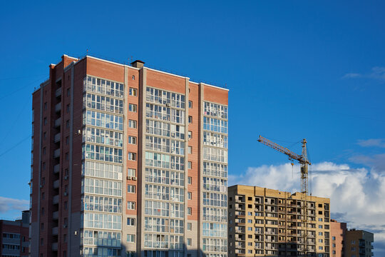 Apartment blocks and a construction site with a tower crane.