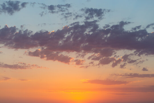 Colorful sunset over the horizon with orange and purple sky, serene coastal view, peaceful scenery, nature beauty.