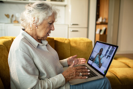 Senior woman consulting doctor online at home