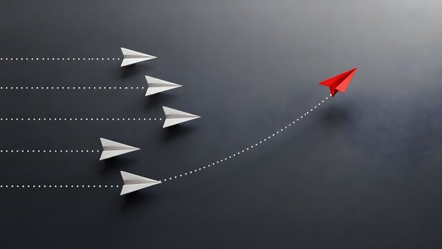 Red paper airplane changing direction from white airplanes representing unique business strategy and leadership concept