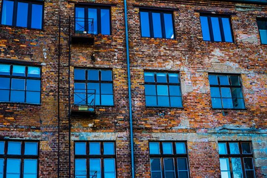 Old brick building with blue windows and fire escape