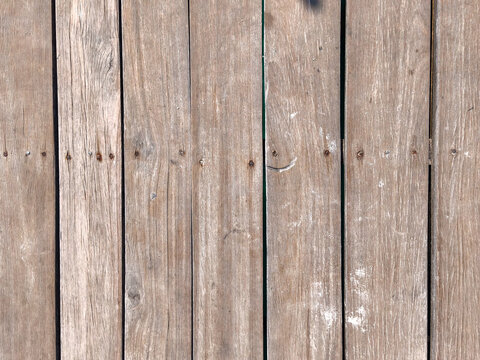 Texture of weathered wooden planks on dock with rusty nails