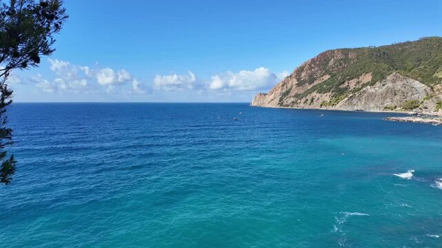 Turquoise sea with rocky headland and gentle waves