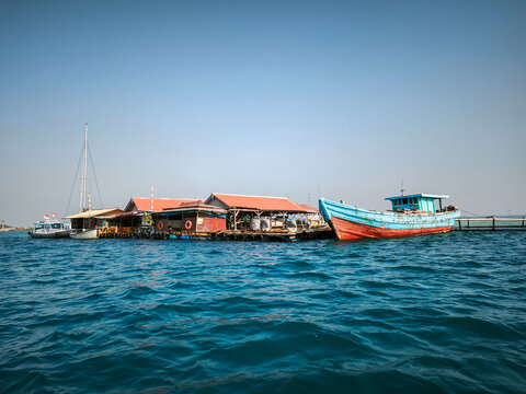 Kepulauan Seribu, Indonesia  September 2026 Traditional floating houses and wooden fishing boats in clear blue sea waters of Thousand Islands.