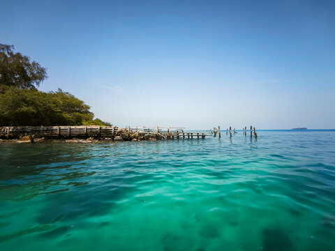 Kepulauan Seribu, Indonesia  06 September 2026 Turquoise tropical sea water near an old wooden pier on the island