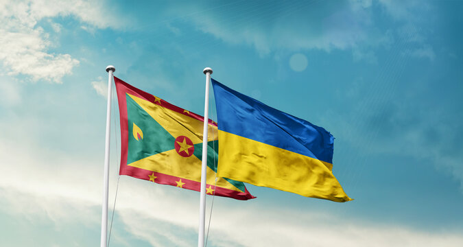 Grenada Ukraine friendship flags are waving in the sky. Two country flag for agreement or deal. Grenada Ukraine national flag for commitment.