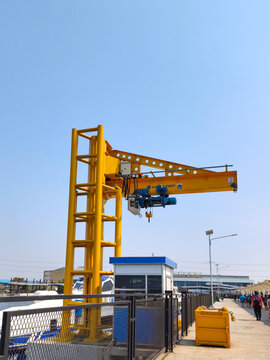 Kota Jakarta, Indonesia  September 6 2026 Yellow jib crane load lifting equipment standing in Muara Angke Port pier area under clear sky