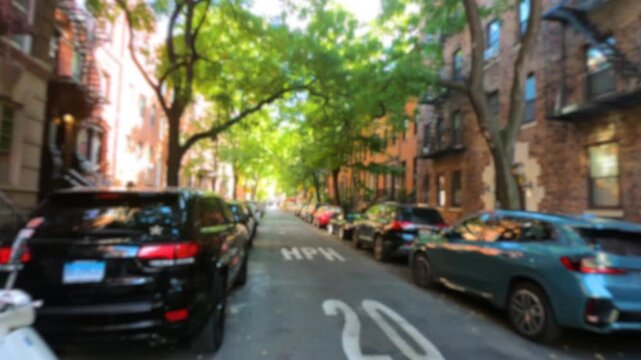 Blurred first person walk along the streets of Greenwich Village in New York City, showing pedestrians and urban surroundings with an intentionally soft focus effect.