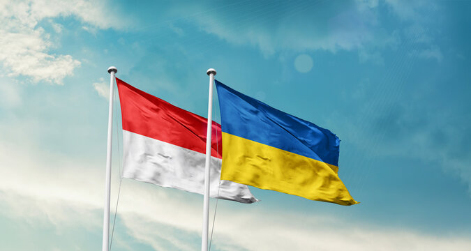 Indonesia Ukraine friendship flags are waving in the sky. Two country flag for agreement or deal. Indonesia Ukraine national flag for commitment.