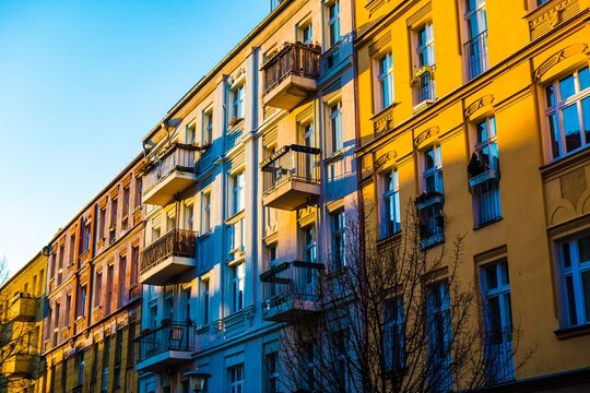 Row of colorful buildings with balconies in sunlight