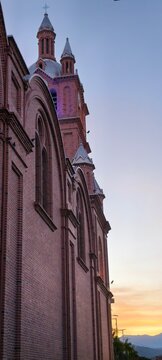 Exterior view of the red brick gothic architecture of the Basilica of the Lord of Miracles in Buga, Colombia