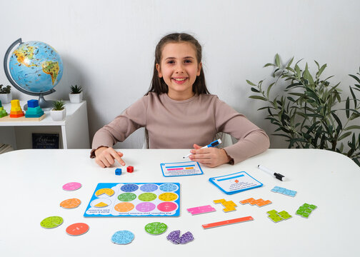 Premium lifestyle product photography showcasing an interactive mathematics game for children. Beautiful retail display template for educational supplies and hobby stores.