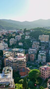 Hillside residential town amid green slopes. View of Rapallo Italy from cable car