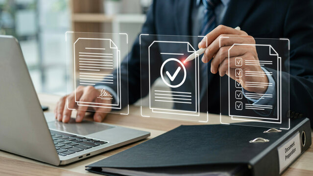 Professional reviewing digital documents on a computer with holographic interface and checklist during office work
