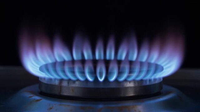Close Side View of Blue Gas Burner Flame with Brief Orange Flame Variation