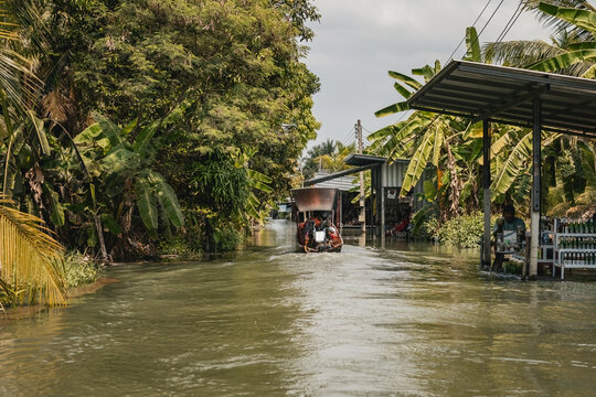 Traditional long boat on the cannal in Bangkok floating village Thailand