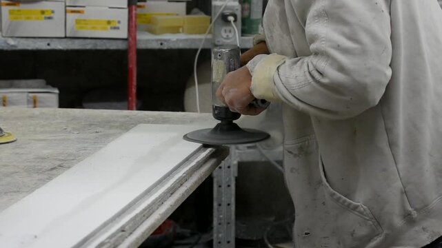Worker Grinding and Finishing Cultured Marble Surface in Slow Motion