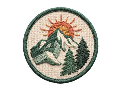  Round embroidered fabric patch of mountains, pine trees, and sun isolated on a transparent background.