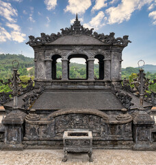Intricate stone carvings and traditional architecture at the Khai Dinh Tomb in Hue, Vietnam, showcasing historical imperial artistry and dragon motifs on a sunny day © Khaled El-Adawi