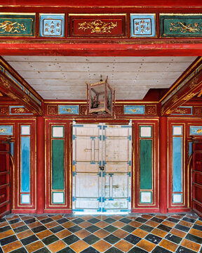 Ornate interior of Sung Duc Pavilion at the Tomb of Minh Mang in Hue, Vietnam, featuring traditional wooden architecture, colorful painted panels, gold leaf details, and a checkered tiled floor