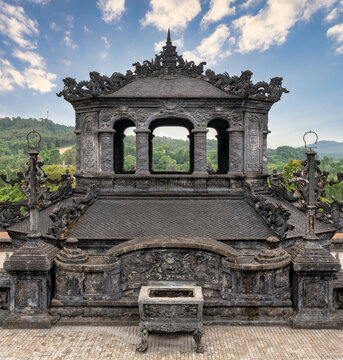 Intricate stone carvings and traditional architecture at the Khai Dinh Tomb in Hue, Vietnam, showcasing historical imperial artistry and dragon motifs on a sunny day