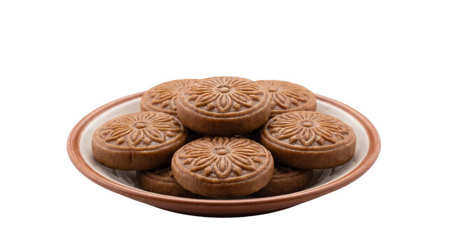 Authentic Brown Nolen Gur Sandesh with embossed floral patterns, on the plate isolated on crisp