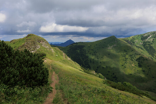 Pekelnik, View from Mlay Krivan, Mala Fatra, Slovakia. Beautiful mountain landscape in summer. Rocks, stones and grassy peaks. Cloudy overcast
