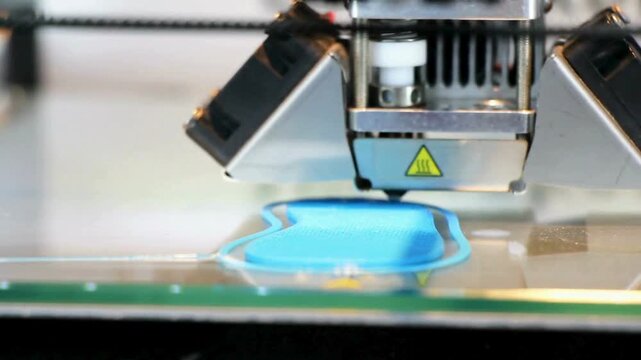 A video showcasing a 3D printer creating a blue object