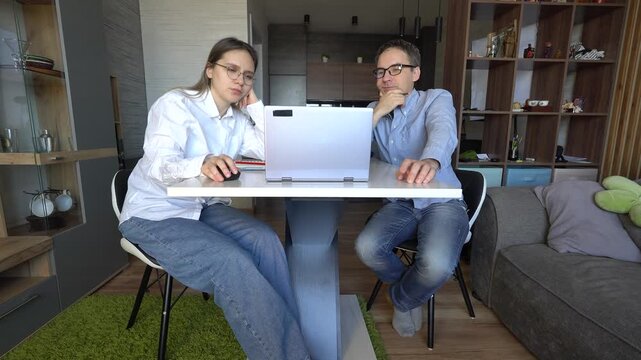 Coworking, couple in office and working together for planning remote work startup strategy online. Small business, man and woman at desk on laptop, networking email and web research at digital agency