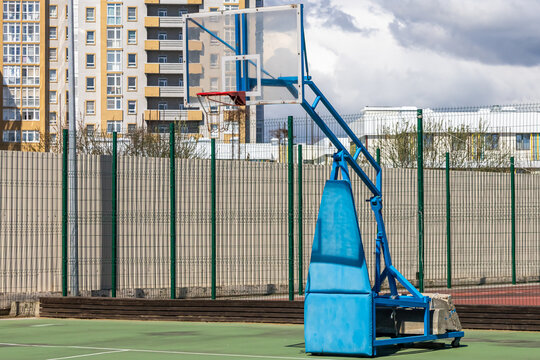 A mobile basketball hoop on a sports ground. Organizing sports events and competitions on the premises. A basketball backboard for backyard use.