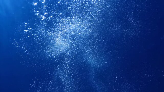 Underwater light rays and floating particles in deep blue ocean