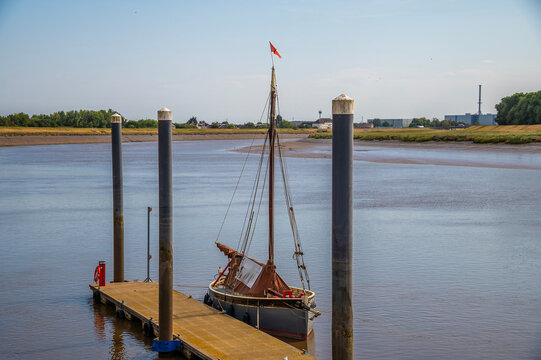A view of a boat moored on the South Quay on the River Great Ouse in King's Lynn, Norfolk, England in summertime
