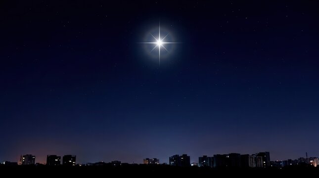 Bright star shining in the dark night sky above a silhouetted city skyline.