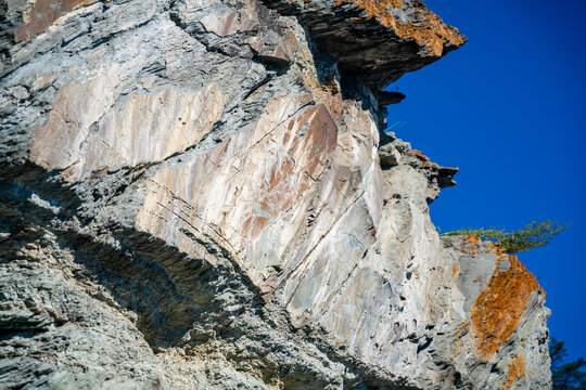 Ancient petroglyphs carved into rock at Tomskaya Pisanitsa in Siberia. Prehistoric rock art represents archaeological heritage and early human culture