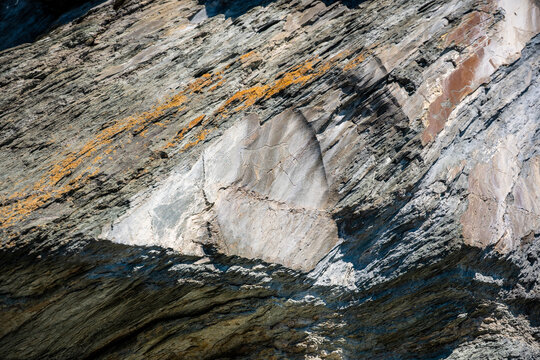 Ancient petroglyphs carved into rock at Tomskaya Pisanitsa in Siberia. Prehistoric rock art represents archaeological heritage and early human culture