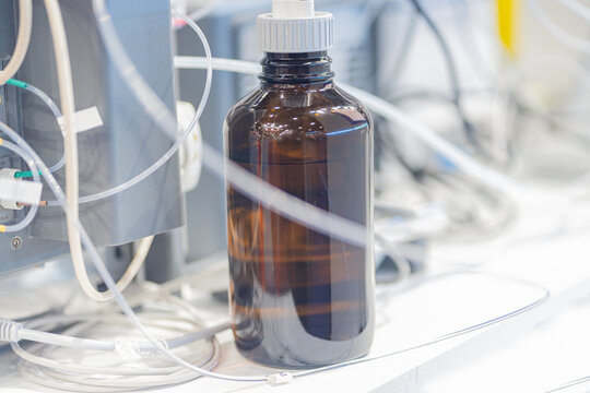 Modern laboratory table with glass flasks bottles Automatic titrator in biochemical laboratory.