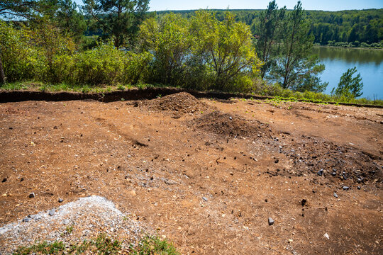 Archaeological excavation site near Tomskaya Pisanitsa in Siberia. Excavated soil layers represent research and discovery of ancient human history