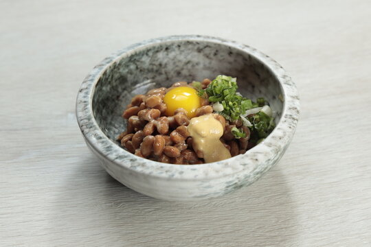 Delicious natto bowl with egg and green onions inviting taste buds to a unique culinary experience