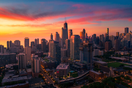 Downtown Chicago skyline under vivid orange sunrise