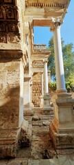 Fototapeta premium Side view of ancient Roman Hadrian's Gate in Antalya, Turkey. Close-up shot of historic marble architecture in Kaleici.